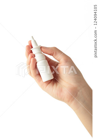 Hand holds a bottle of nasal drops isolated on white background. 124094105