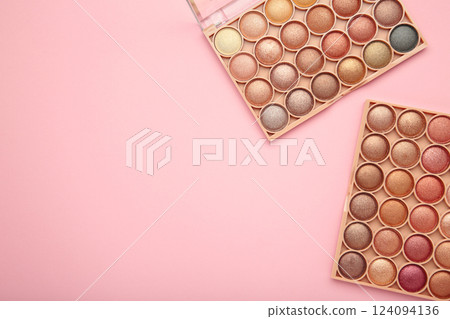 Pastel palette of eyeshadow on pink background. Space for text Pastel palette of eyeshadow on pink background. Space for text 124094136