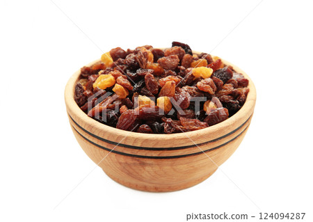 Raisins in wooden bowl isolated on white background. Raisins in wooden bowl isolated on white background. 124094287