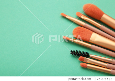 Professional female cosmetics brushes for makeup and eyelash brush on mint background. Cosmetics concept, make up concept 124094348
