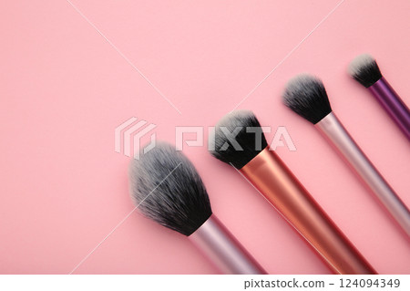 Professional female cosmetics brushes for makeup and eyelash brush on pink background. Cosmetics concept, make up concept Professional female cosmetics brushes for makeup and eyelash brush on pink background. Cosmetics concept, make up concept 124094349