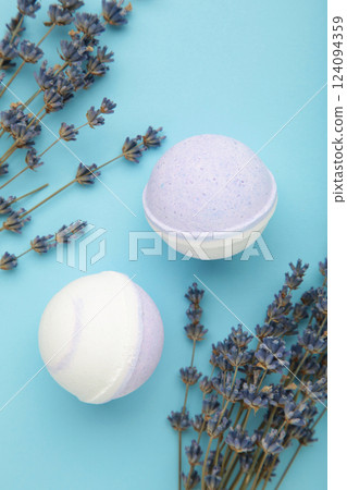 Natural cosmetics. Handmade lavender bath bombs and lavender flowers on blue background. 124094359