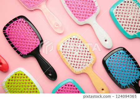 Set of hairbrushes on pink background. Flat lay Set of hairbrushes on pink background. Flat lay 124094365