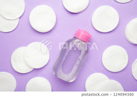 Micellar cleansing water and cotton pads on pink background Micellar cleansing water and cotton pads on pink background 124094380