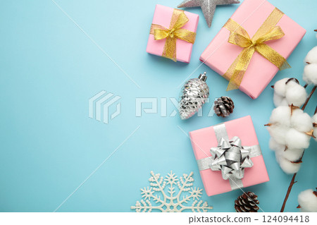 Christmas composition. Pink gifts, silver decorations on blue background. New year concept. Christmas composition. Pink gifts, silver decorations on blue background. New year concept. 124094418
