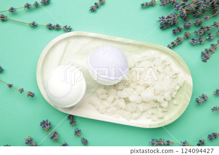 Natural cosmetics. Handmade lavender bath bombs and lavender flowers on board on mint background. Natural cosmetics. Handmade lavender bath bombs and lavender flowers on board on mint background. 124094427