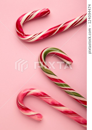 Christmas candy cane on pink background. Top view Christmas candy cane on pink background. Top view 124094474