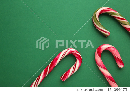 Christmas candy cane on green background. Top view Christmas candy cane on green background. Top view 124094475