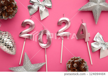 2024 Happy New Year and silver Christmas decoration on pink background. 2024 Happy New Year and silver Christmas decoration on pink background. 124094484