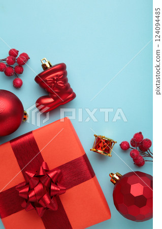 Christmas composition. Gifts, red decorations on blue background. New year concept. Vertical photo 124094485