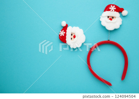 Christmas headband Santa Claus head design on blue background. Space for text 124094504