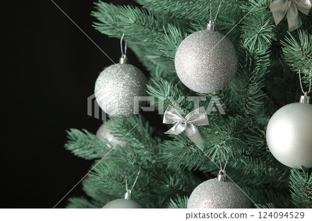 Christmas tree with silver balls on dark background. Christmas card with white silver decor Christmas tree with silver balls on dark background. Christmas card with white silver decor 124094529