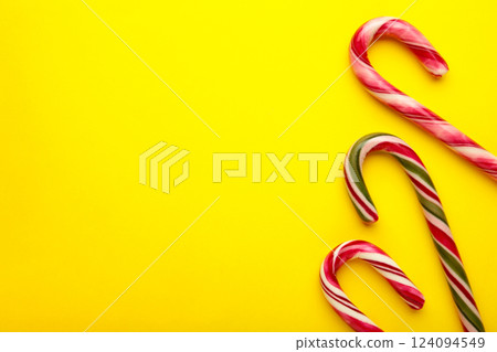 Christmas candy cane on yellow background. Top view Christmas candy cane on yellow background. Top view 124094549