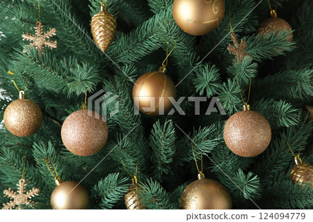 Christmas tree with gald balls on dark background. Christmas card with gold decor 124094779