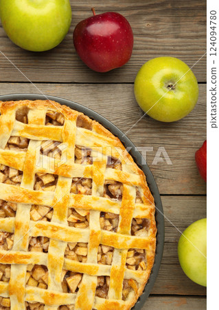 Homemade sweet american apple pie with sugar and cinnamon. Tart with apple on grey background. Vertical photo Homemade sweet american apple pie with sugar and cinnamon. Tart with apple on grey background. Vertical photo 124094780