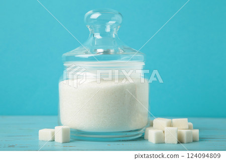 Jar with white sugar on blue background. Space for text Jar with white sugar on blue background. Space for text 124094809