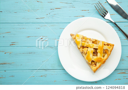 Homemade organic apple pie dessert ready to eat on blue wooden background. 124094818