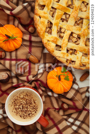 Apple pie and coffee with autumn decoration on blanket. Apple pie and coffee with autumn decoration on blanket. 124094819
