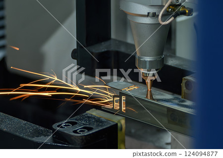 Close up scene the fiber laser cutting machine cut the square shape stainless steel tube with sparkling light. 124094877