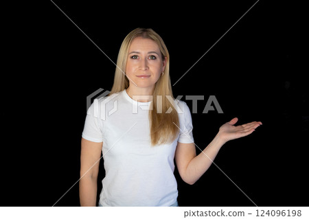 positive young blonde woman pointing aside with fingers hand gesture at copy space advertising product, presenting sale discount promo offer standing isolated on black background. positive young blonde woman pointing aside with fingers hand gesture at copy space advertising product, presenting sale discount promo offer standing isolated on black background. 124096198