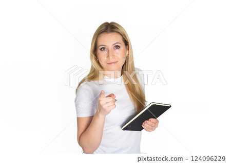 Young blonde business woman wear white shirt white t-shirt writing down in notebook diary remind memories make list dreams isolated on white background studio People lifestyle concept 124096229