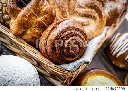 Fresh baked bread, various delicious freshly baked bread on white background, copy space. Variety of artisan bread composition, top view 124096399