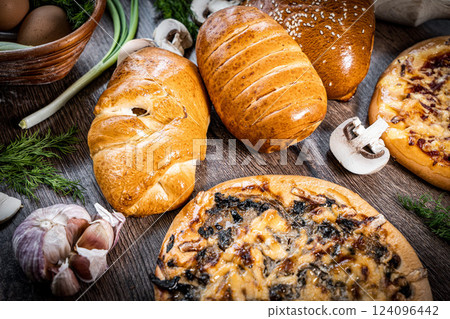 Pie and homemade bread, pizza or pie ingridients, food flat lay on kitchen table background. Working with butter, milk, yeast, flour, eggs, sugar pastry or bakery cooking. Text space 124096442