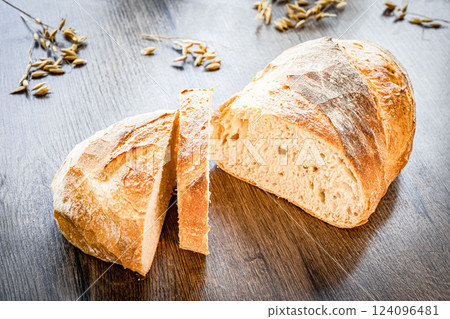 Craft sliced bread on the table at the bakery. The concept of small industries and healthy food Craft sliced bread on the table at the bakery. The concept of small industries and healthy food 124096481