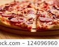 Freshly baked pepperoni pizza features a crispy crust, melted cheese, and savory toppings. Perfect for sharing during a casual meal with friends or family 124096960
