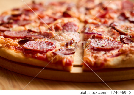 Freshly baked pepperoni pizza features a crispy crust, melted cheese, and savory toppings. Perfect for sharing during a casual meal with friends or family 124096960