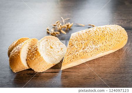 Craft sliced bread on the table at the bakery. The concept of small industries and healthy food Craft sliced bread on the table at the bakery. The concept of small industries and healthy food 124097123