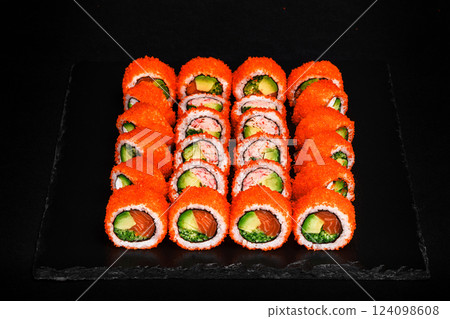 Delicious Fresh Sushi Rolls Set Presenting Exquisitely on a Black Background Delicious Fresh Sushi Rolls Set Presenting Exquisitely on a Black Background 124098608