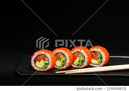 Delicious Fresh Salmon Sushi Rolls Presenting Exquisitely on a Black Background Delicious Fresh Salmon Sushi Rolls Presenting Exquisitely on a Black Background 124098610
