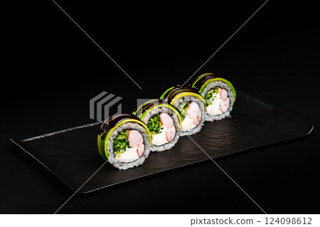Fresh Sushi avocado shrimp Rolls Presenting Exquisitely on a Black Background Fresh Sushi avocado shrimp Rolls Presenting Exquisitely on a Black Background 124098612