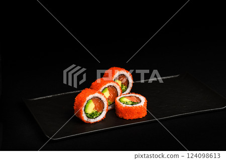 Delicious Fresh Salmon Sushi Rolls Presenting Exquisitely on a Black Background 124098613