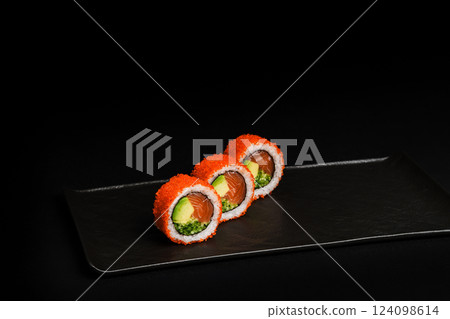 Delicious Fresh Salmon Sushi Rolls Presenting Exquisitely on a Black Background 124098614
