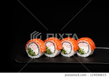 Delicious Fresh Salmon Sushi Rolls Presenting Exquisitely on a Black Background 124098615