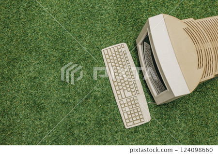 Vintage PC on green grass, top view.  124098660