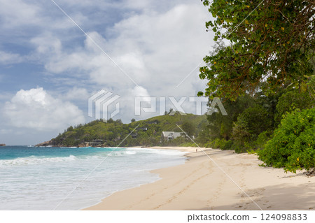 Idyllic ocean scene showcasing a tranquil sandy beach Idyllic ocean scene showcasing a tranquil sandy beach 124098833