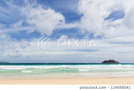 Peaceful beach with gentle waves lapping against the sand 124098841