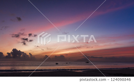 A breathtaking sunset over the tranquil ocean A breathtaking sunset over the tranquil ocean 124098846