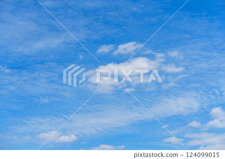 Breathtaking Fluffy White Clouds Drifting Across a Deep Blue Sky Ideal for Travel and Nature Themes 124099015