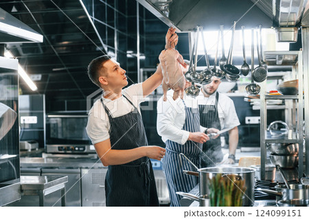 Preparing chicken. Chef is on the kitchen making food 124099151