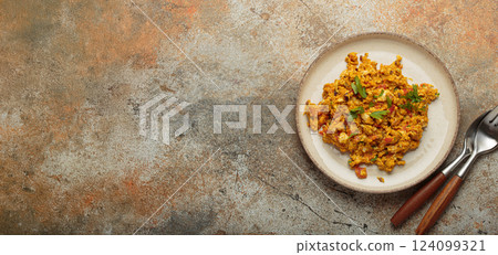 Plate of akuri indian style scrambled eggs with spices and herbs top view with copy space Plate of akuri indian style scrambled eggs with spices and herbs top view with copy space 124099321