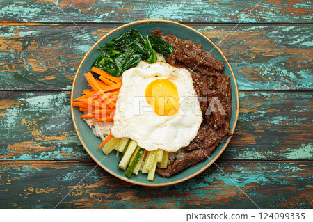 Traditional korean dish bibimbap with fried egg on top, top view 124099335