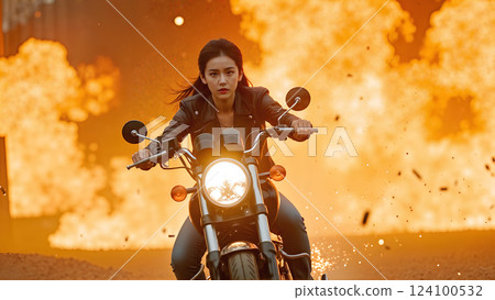 Fearless woman on motorcycle escaping explosive fire in action-packed scene 124100532