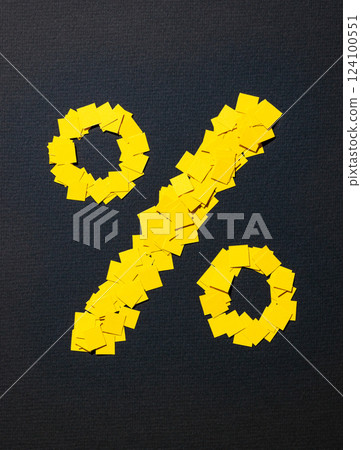 percent sign made from small pieces of yellow colored applique paper squares 124100551