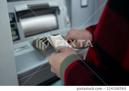 Close-Up of a Man Taking Money from an ATM, Cash Withdrawal Close-Up of a Man Taking Money from an ATM, Cash Withdrawal 124100569