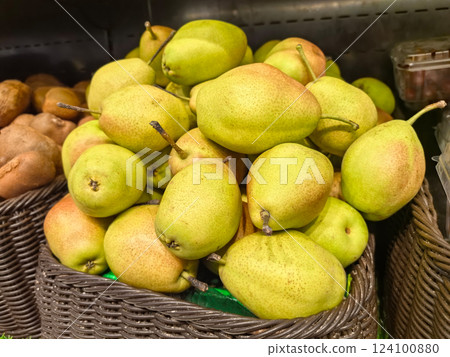 Fresh green pears stacked in a market display ready for purchase 124100880