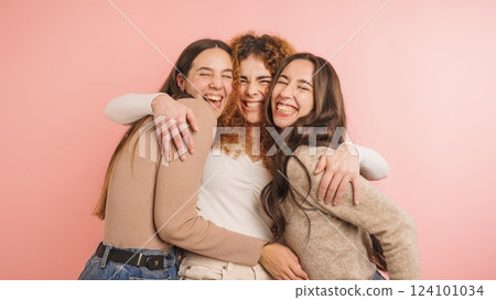 Three joyful friends embracing with laughter Three joyful friends embracing with laughter 124101034